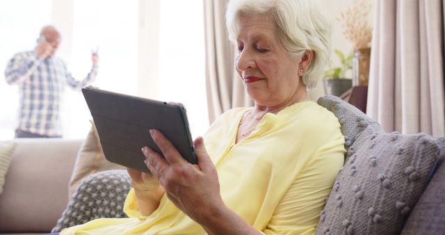 Senior Woman Using Tablet On Sofa At Home - Download Free Stock Images Pikwizard.com