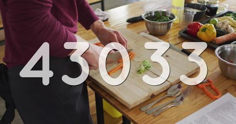 Chef Chopping Carrots in Modern Kitchen for Healthy Meal Prep