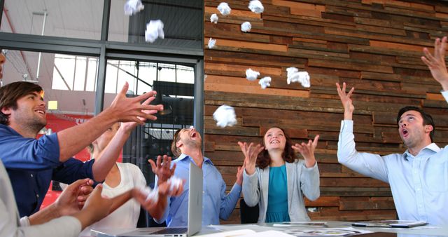 Team Celebrating Success by Throwing Paper in Modern Office - Download Free Stock Images Pikwizard.com