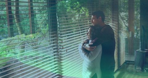 Couple Embracing Peacefully by Window Blinds