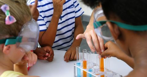 Teacher Guiding Young Students in Science Experiment Laboratory - Download Free Stock Images Pikwizard.com