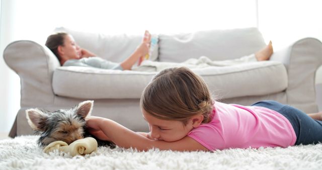 Girl Cuddling Puppy with Woman Relaxing on Couch at Home - Download Free Stock Images Pikwizard.com