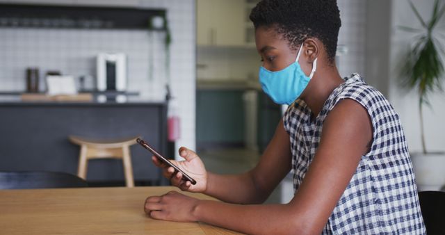 Woman Wearing Mask Using Smartphone in Modern Home - Download Free Stock Images Pikwizard.com