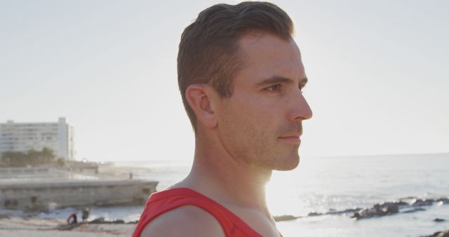 Fit Man in Red Tank Top Looking Out at Beach - Download Free Stock Images Pikwizard.com