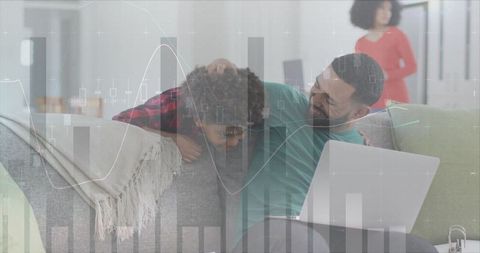 Father and Son Bonding While Using Laptop Analyzing Data