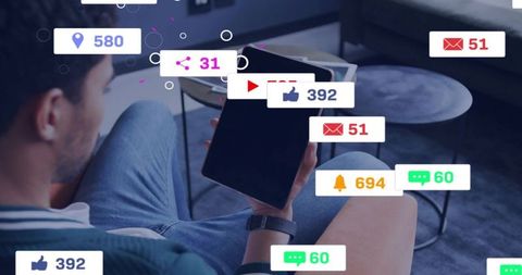 Man holding and viewing tablet with floating social media notifications and engagement badges