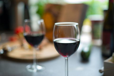 Red Wine Glass in Focus on Casual Dining Table with Blurred Background