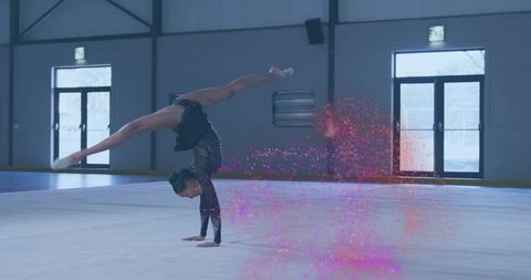 Gymnast Performing One-Arm Handstand Split with Artistic Flair in Gym