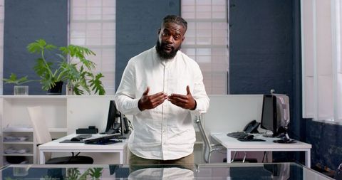 Confident Businessman Giving Office Presentation