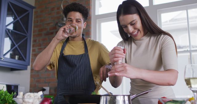 Couple Cooking Together in Modern Kitchen Laughing and Enjoying Time - Download Free Stock Images Pikwizard.com