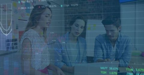 Team reviewing laptop data and charts in modern workspace collaborating on strategy