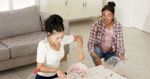 Two Women Celebrating with Confetti at Home