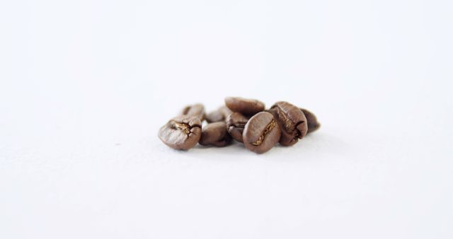 Close-Up of Freshly Roasted Coffee Beans on White Background - Download Free Stock Images Pikwizard.com