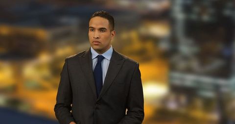 Confident news anchor delivering report in studio