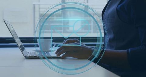 Business person typing on laptop in modern workspace