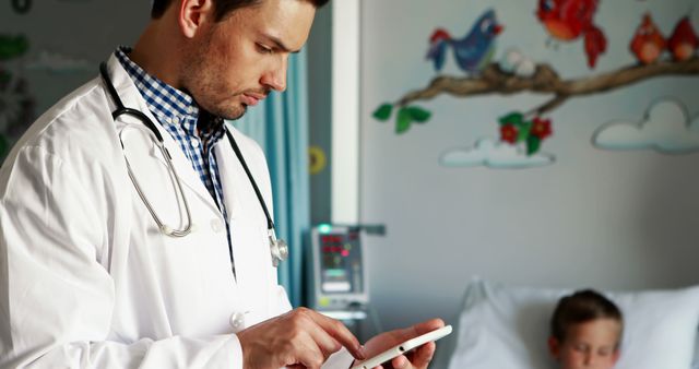 Pediatrician Using Tablet While Caring for Sick Child in Hospital Room - Download Free Stock Images Pikwizard.com