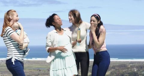 Multiracial Women Celebrating Outdoors with Baby