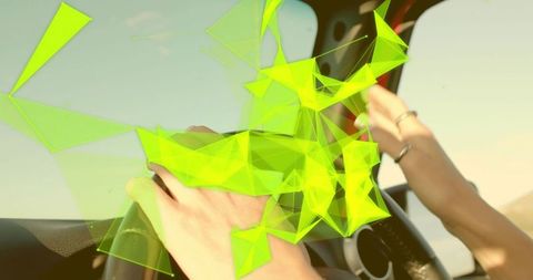 Person driving with futuristic neon digital overlay