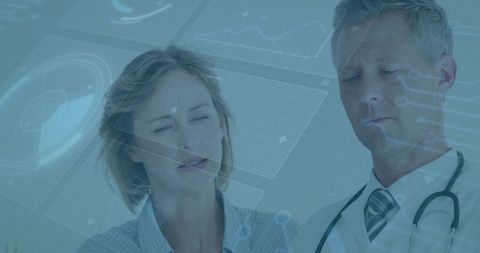 Doctors reviewing digital patient data on transparent medical dashboard for diagnostics