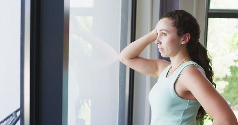 Pensive Caucasian Woman Gazing Out Sunlit Window - Download Free Stock Images Pikwizard.com