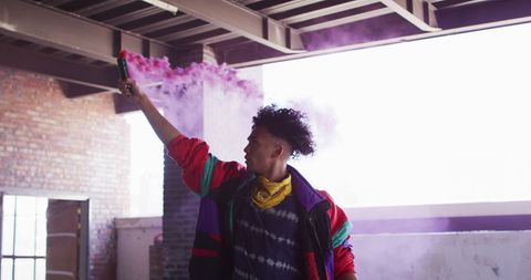 Expressive Youth with Purple Smoke in Urban Setting