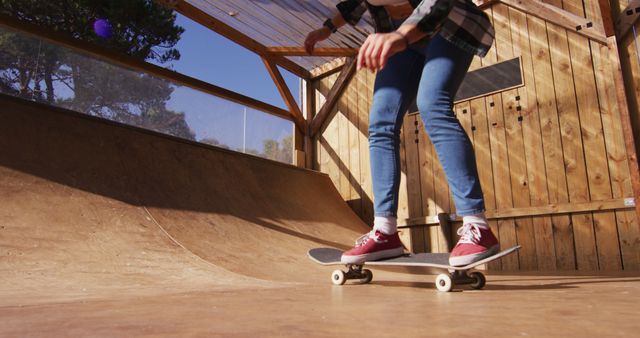Image of legs of caucasian female skateboarder in skate park. Skateboarding, sport and hobby concept digitally generated image.