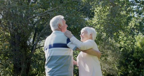 Happy Senior Couple Dancing Joyfully in Sunny Garden - Download Free Stock Images Pikwizard.com