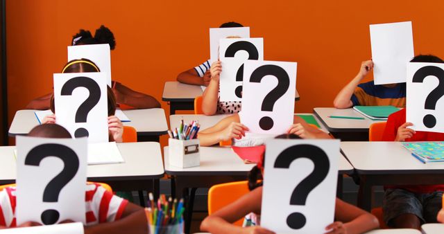 School kids covering their face with question mark sign in classroom at school 4k