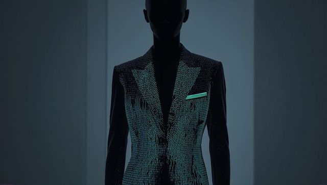 Shimmering iridescent tailored jacket silhouette with teal pocket square