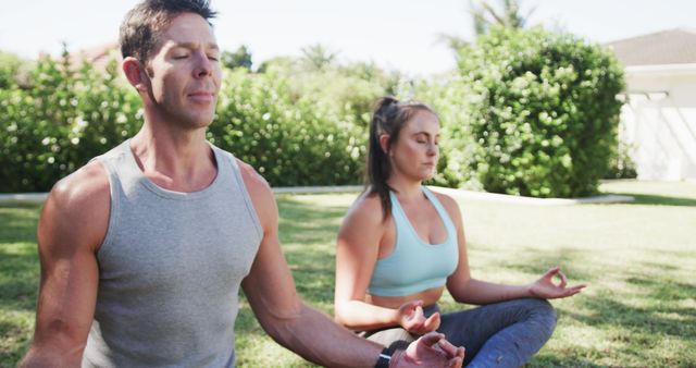 Man and Woman Meditating Outdoors in Sunlit Garden - Download Free Stock Images Pikwizard.com