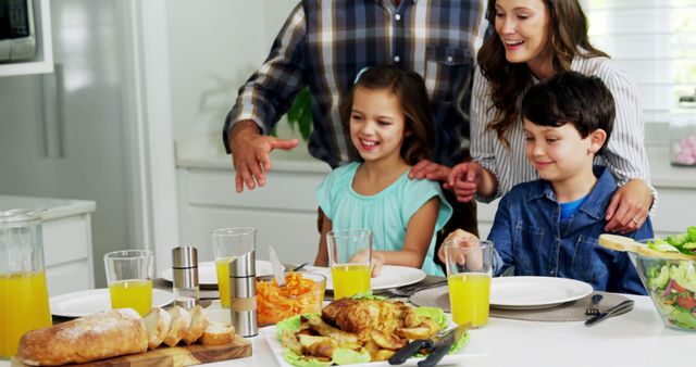 Family Enjoying Meal Around Table with Fresh Food and Juices - Download Free Stock Images Pikwizard.com