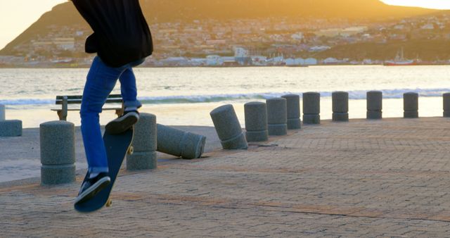 Teen Performing Skateboarding Trick Next to Ocean at Sunset - Download Free Stock Images Pikwizard.com