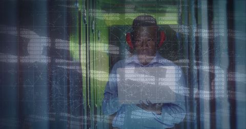 African American IT Professional Analyzing Server Room Data