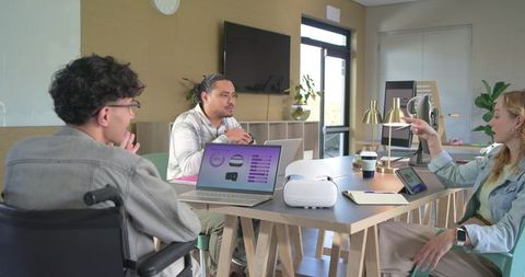 Diverse team conducting vr design review in modern accessible workspace