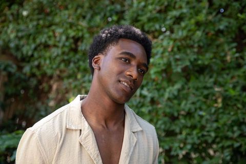 African american man relaxing in lush greenery