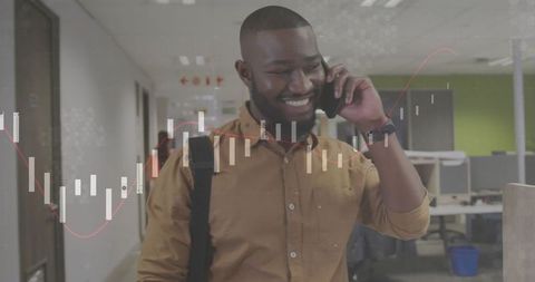 Professional Man Walking Through Office While on Phone Call