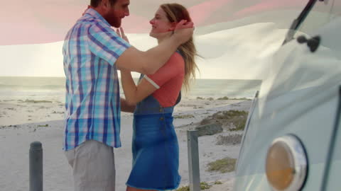 Romantic Couples Embracing by Seaside with Beach Camper Van