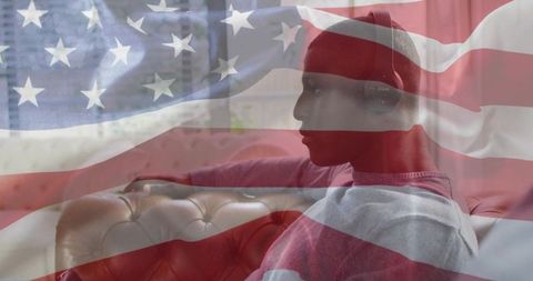 Man relaxing with headphones on couch with american flag overlay