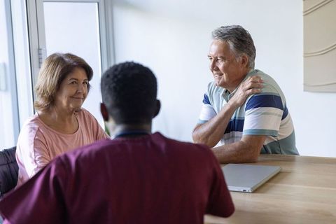 Couple consulting clinician at private clinic discussing care plan and treatment options