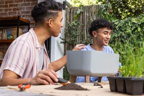 Father and Son Bonding Through Gardening on Patio