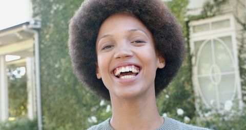 Smiling Woman Enjoying a Sunny Day at Home