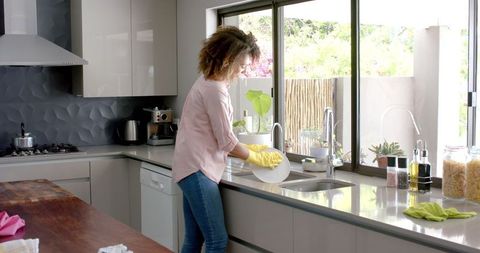 Woman Enjoying House Chores Washing Dishes in Bright Kitchen - Download Free Stock Images Pikwizard.com