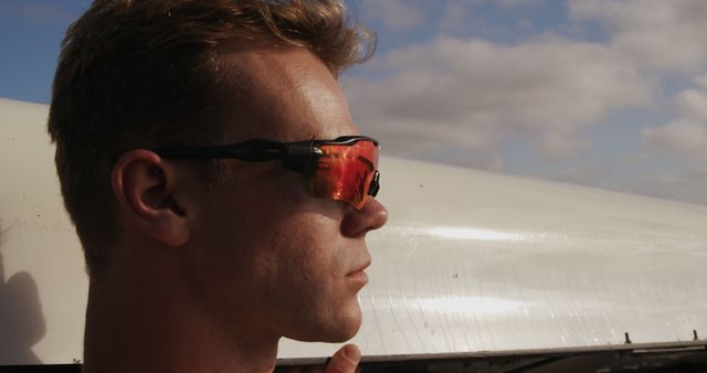 Man with Red Reflective Sunglasses Looking into Distance - Download Free Stock Images Pikwizard.com