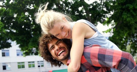 Smiling Biracial Friends Piggyback Outdoors Under Sunny Sky - Download Free Stock Images Pikwizard.com