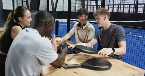Diverse friends enjoying padel court recreation