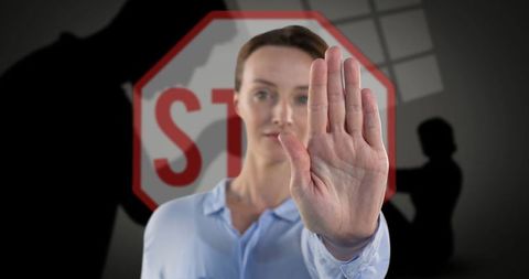 Woman making stop gesture to highlight domestic violence