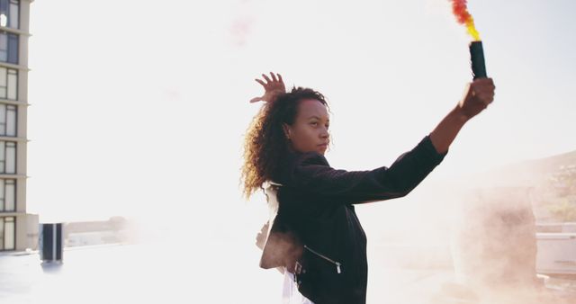 Woman Holding Smoke Bomb on Rooftop in Bright Sunlight - Download Free Stock Images Pikwizard.com