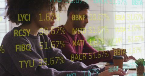 Multiracial Team Analyzing Stock Market Data on Laptops