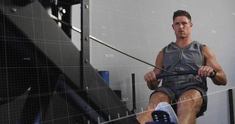 Focused Man Exercising on Rowing Machine with Digital Overlay