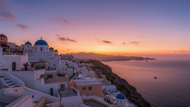 Sunset over santorini village with blue domes and sea